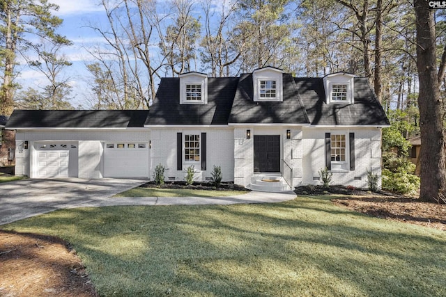 cape cod home with a garage and a front lawn