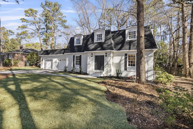 cape cod home featuring a garage and a front lawn