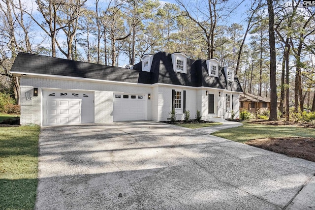 view of front of property with a garage and a front yard