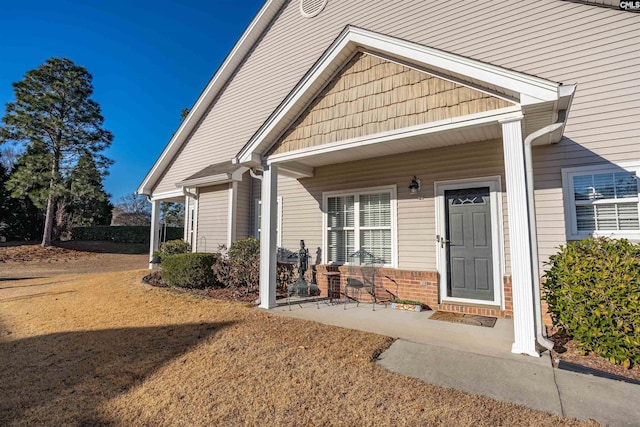 entrance to property featuring a lawn