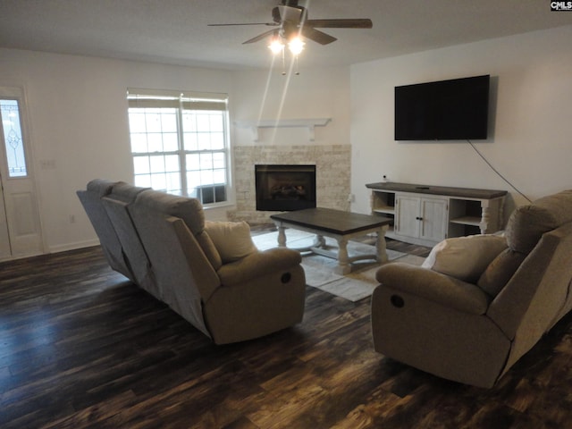 living room featuring dark wood-type flooring and ceiling fan