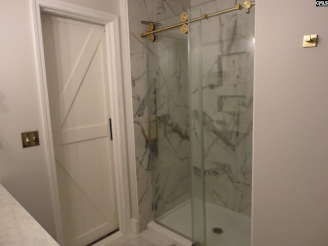 bathroom with a shower with shower door