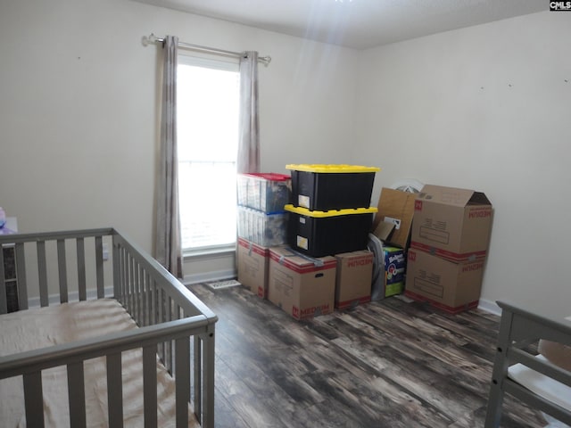 bedroom with dark hardwood / wood-style flooring