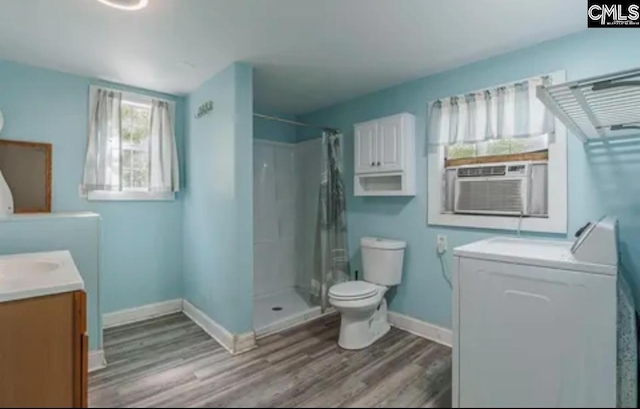 bathroom featuring toilet, a shower with curtain, hardwood / wood-style flooring, vanity, and cooling unit