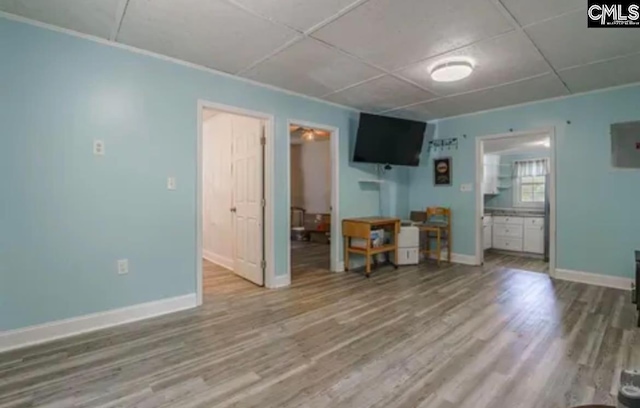 living room with hardwood / wood-style flooring and a paneled ceiling