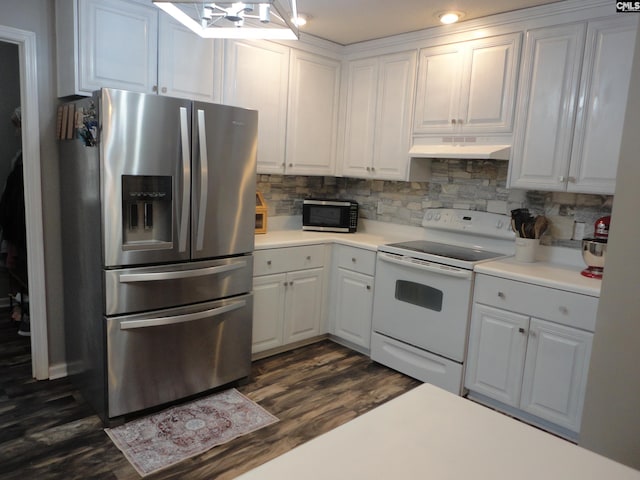 kitchen with electric stove, dark wood-type flooring, stainless steel fridge, backsplash, and white cabinets