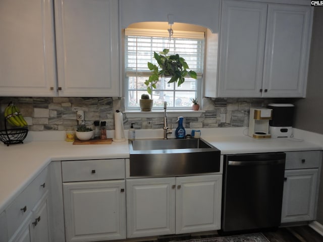 kitchen featuring white cabinetry, dishwasher, sink, and decorative backsplash