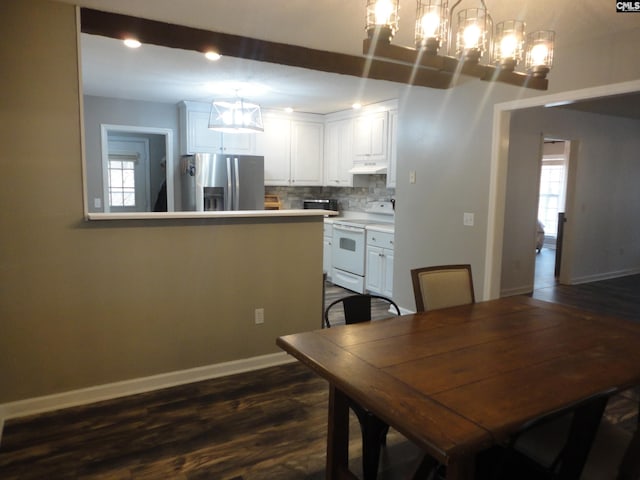 dining room with a notable chandelier and dark hardwood / wood-style floors