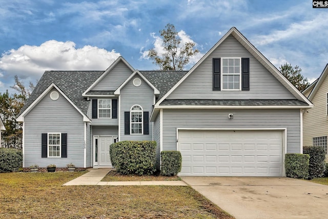 front of property with a garage and a front lawn