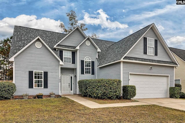 view of front of home featuring a garage and a front lawn