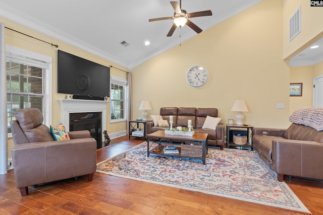 living room with crown molding, ceiling fan, high vaulted ceiling, and hardwood / wood-style floors