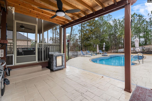 view of swimming pool featuring ceiling fan and a patio