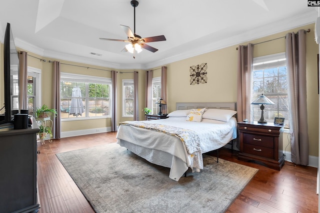 bedroom featuring dark wood-type flooring, ceiling fan, and crown molding