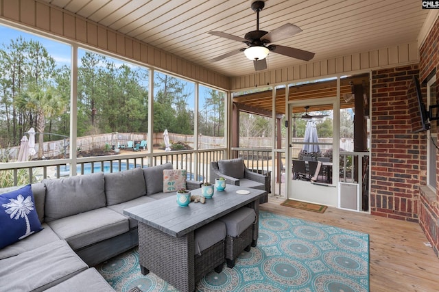 unfurnished sunroom with wooden ceiling and ceiling fan