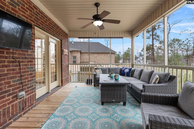 sunroom / solarium featuring ceiling fan, a healthy amount of sunlight, and wooden ceiling