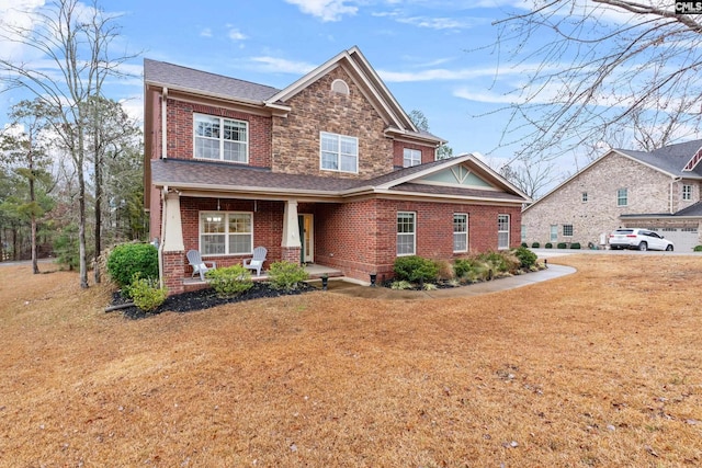 craftsman inspired home with a porch and a front yard