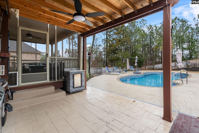 view of swimming pool with a patio and ceiling fan