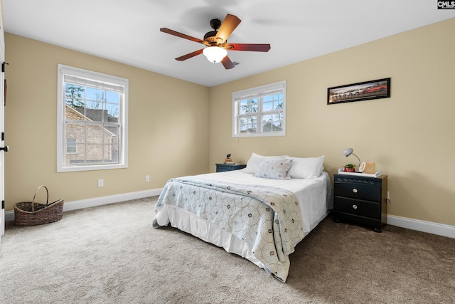 bedroom featuring multiple windows, carpet floors, and ceiling fan