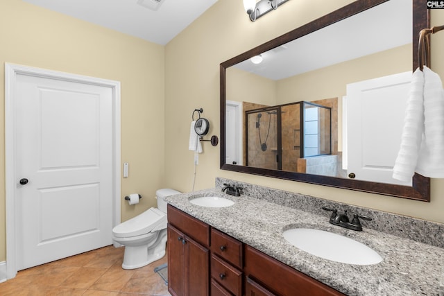 bathroom featuring vanity, toilet, tile patterned floors, and a shower with shower door