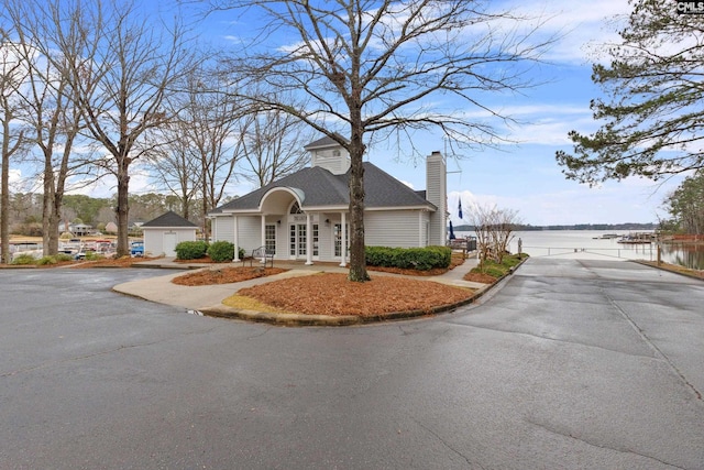 view of front of house with a water view