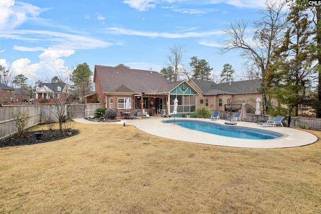 view of swimming pool with a yard and a patio area