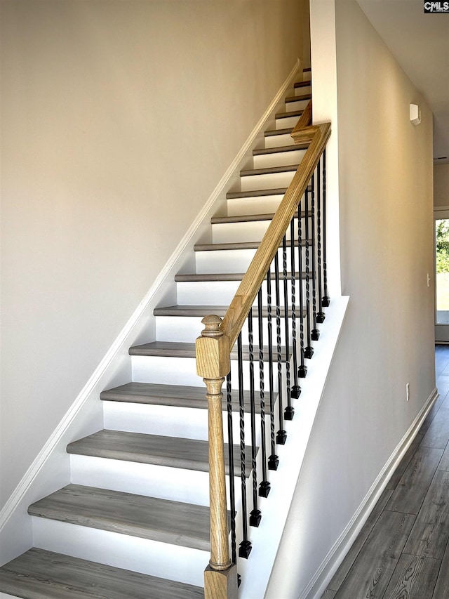 stairs with wood-type flooring