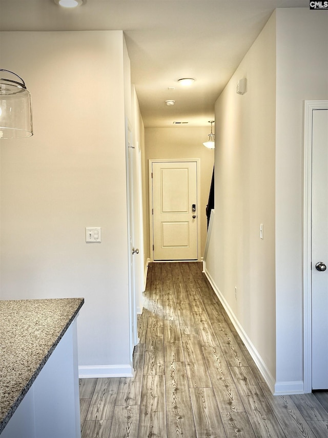 hall with light hardwood / wood-style floors