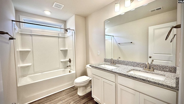 full bathroom featuring toilet, hardwood / wood-style floors, vanity, and shower / bathing tub combination