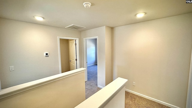 hallway with carpet floors