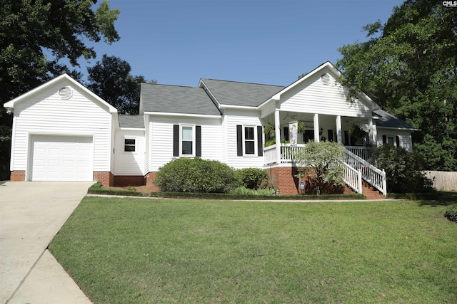 ranch-style home featuring a garage, a front lawn, and covered porch