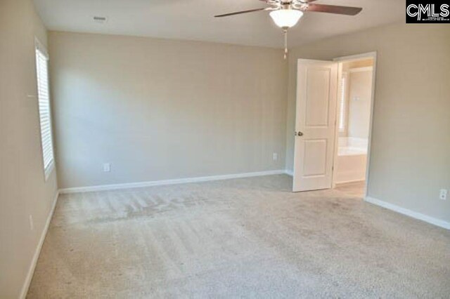 carpeted spare room with ceiling fan