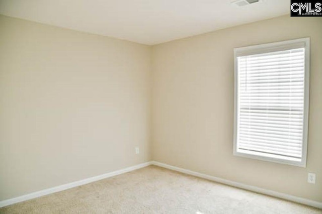 spare room featuring light colored carpet