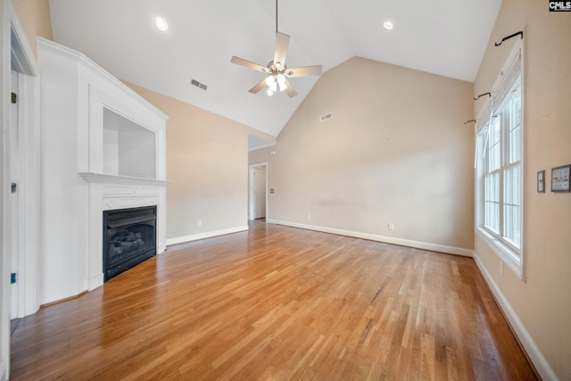 unfurnished living room featuring high vaulted ceiling, ceiling fan, and light hardwood / wood-style flooring