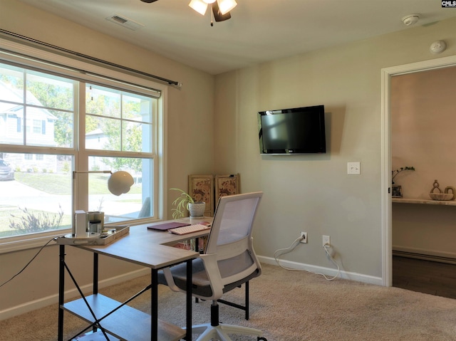 carpeted home office with ceiling fan