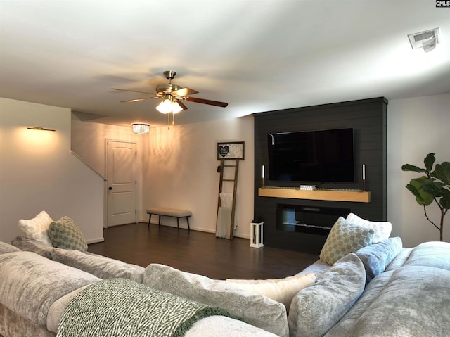 living room with dark hardwood / wood-style floors, a fireplace, and ceiling fan