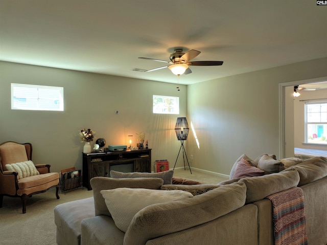 carpeted living room with ceiling fan