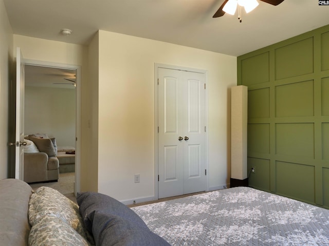 bedroom featuring ceiling fan and a closet