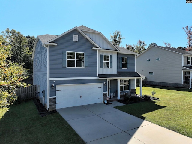 view of front of home featuring a garage, covered porch, and a front lawn