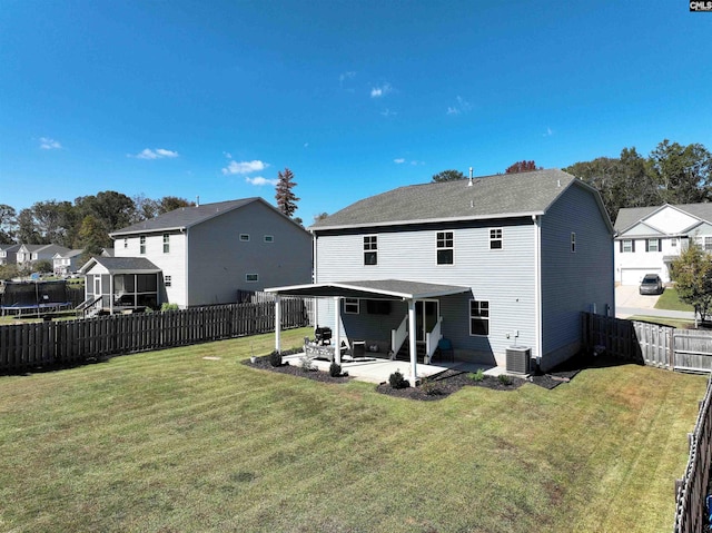 back of house with cooling unit, a patio, and a lawn