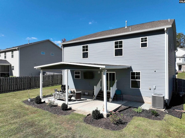 rear view of house with a yard, central AC, and a patio area