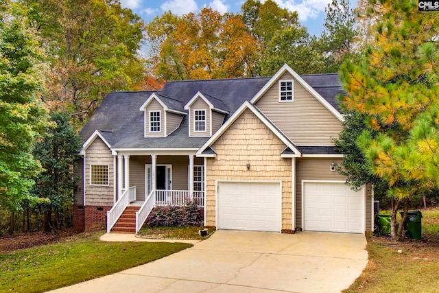 view of front of home with a garage, a front yard, and a porch