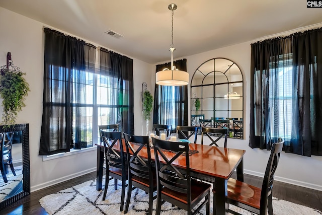 dining space with dark hardwood / wood-style floors