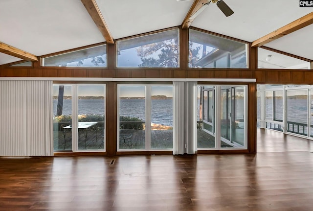 interior space featuring a water view, vaulted ceiling with beams, and ceiling fan