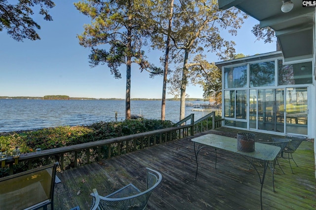 wooden deck featuring a water view and a sunroom