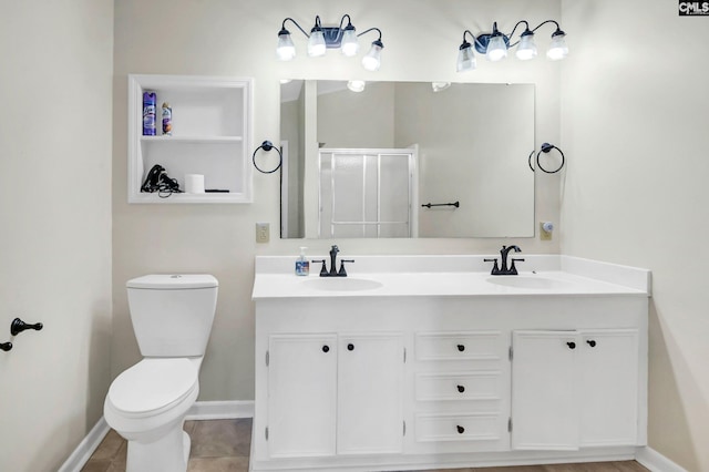 bathroom with vanity, toilet, a shower with shower door, and tile patterned flooring