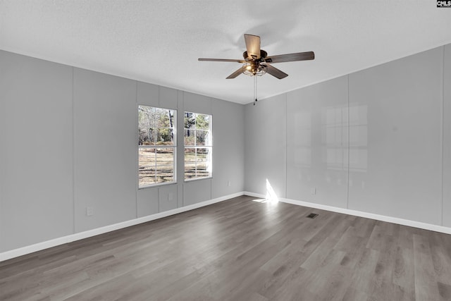 spare room with hardwood / wood-style floors, a textured ceiling, and ceiling fan