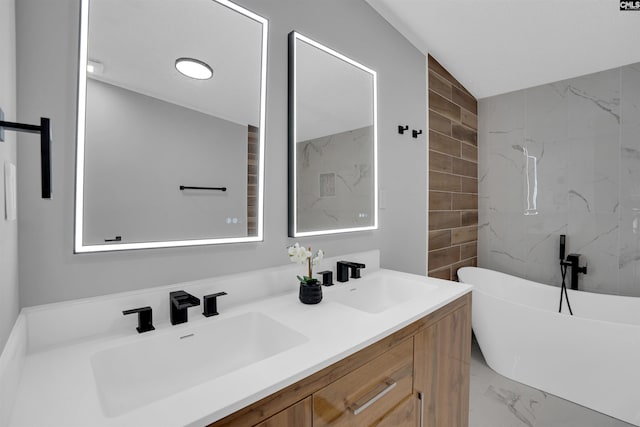 bathroom featuring a washtub, vanity, and tile walls