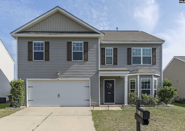 view of front of property with a garage and a front lawn