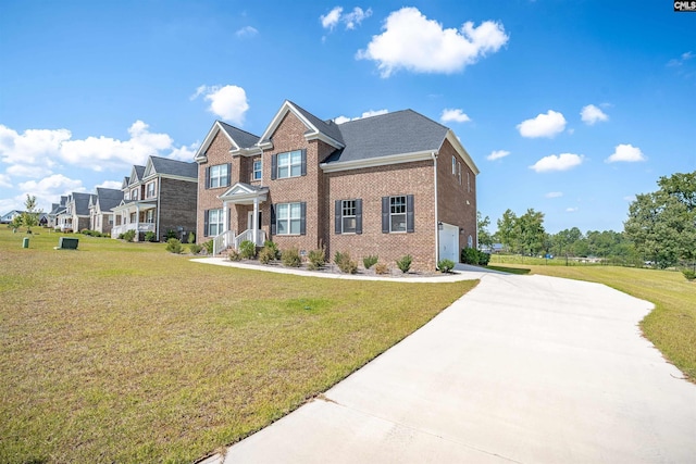 view of front of property featuring a garage and a front lawn