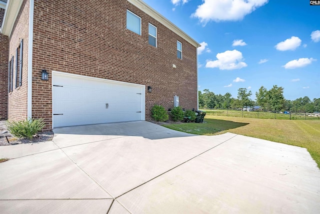 view of side of property with a yard and a garage